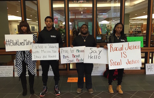 Fairfield University students prepared to take part in a campus demonstration where they were joined by university president Fr. Jeffrey von Arx, S.J., to stand in solidarity with the students of color around the country whose lives were threatened, who feel unsafe or undervalued.